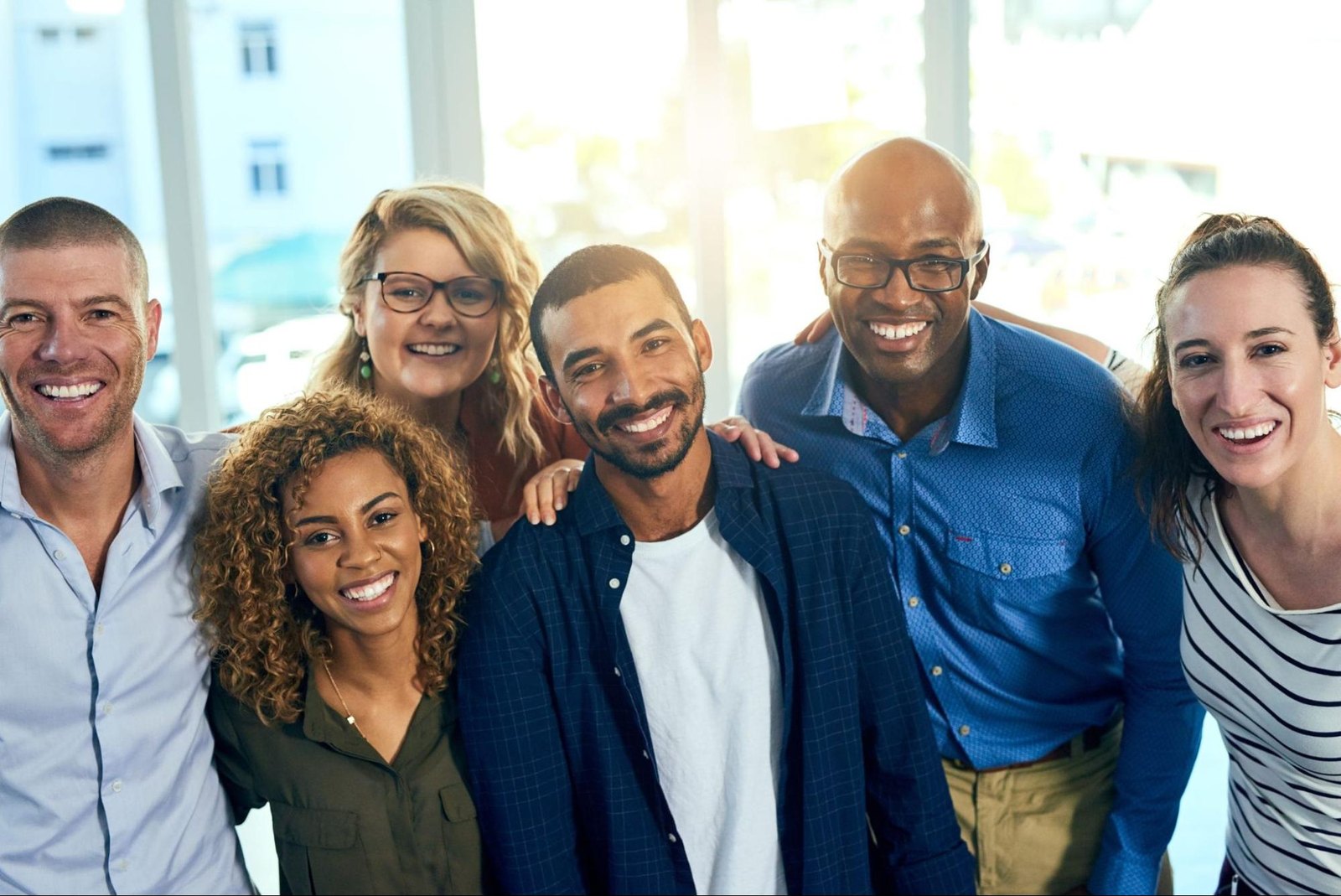 Six mental health professionals standing together, smiling